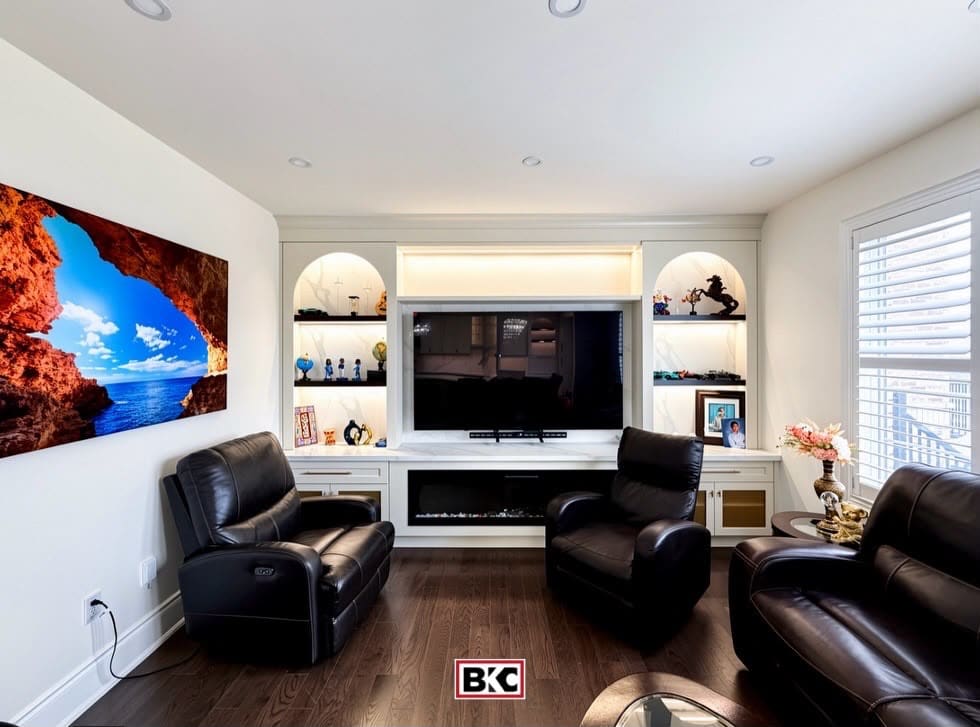 White media wall with lit arched niches and an electric fireplace