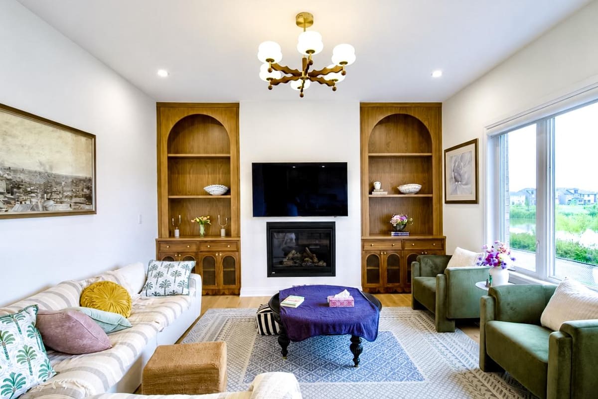Living room with arched walnut built-ins on both sides of the fireplace