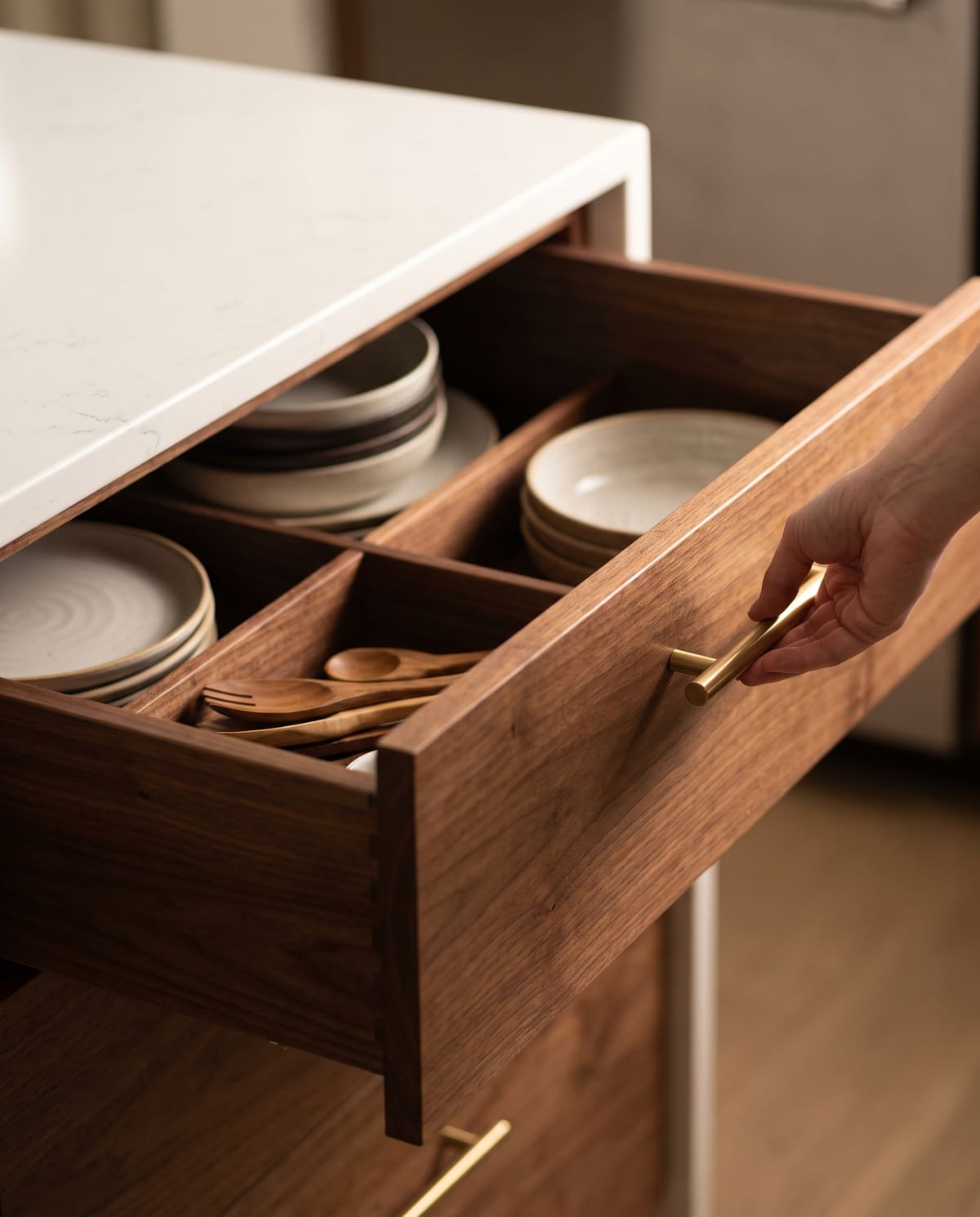 A soft-close walnut drawer with built-in dividers