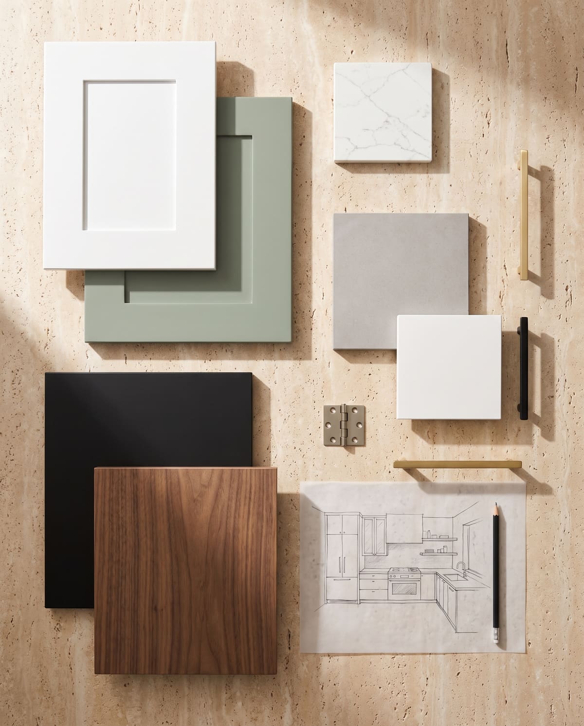Cabinet door samples, quartz squares and hardware laid out on a table