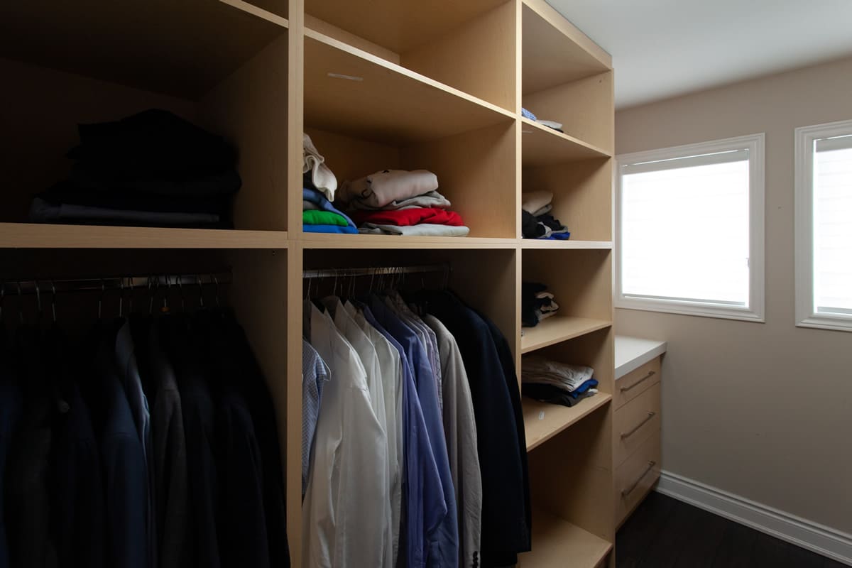 Walk-in closet with light wood shelving