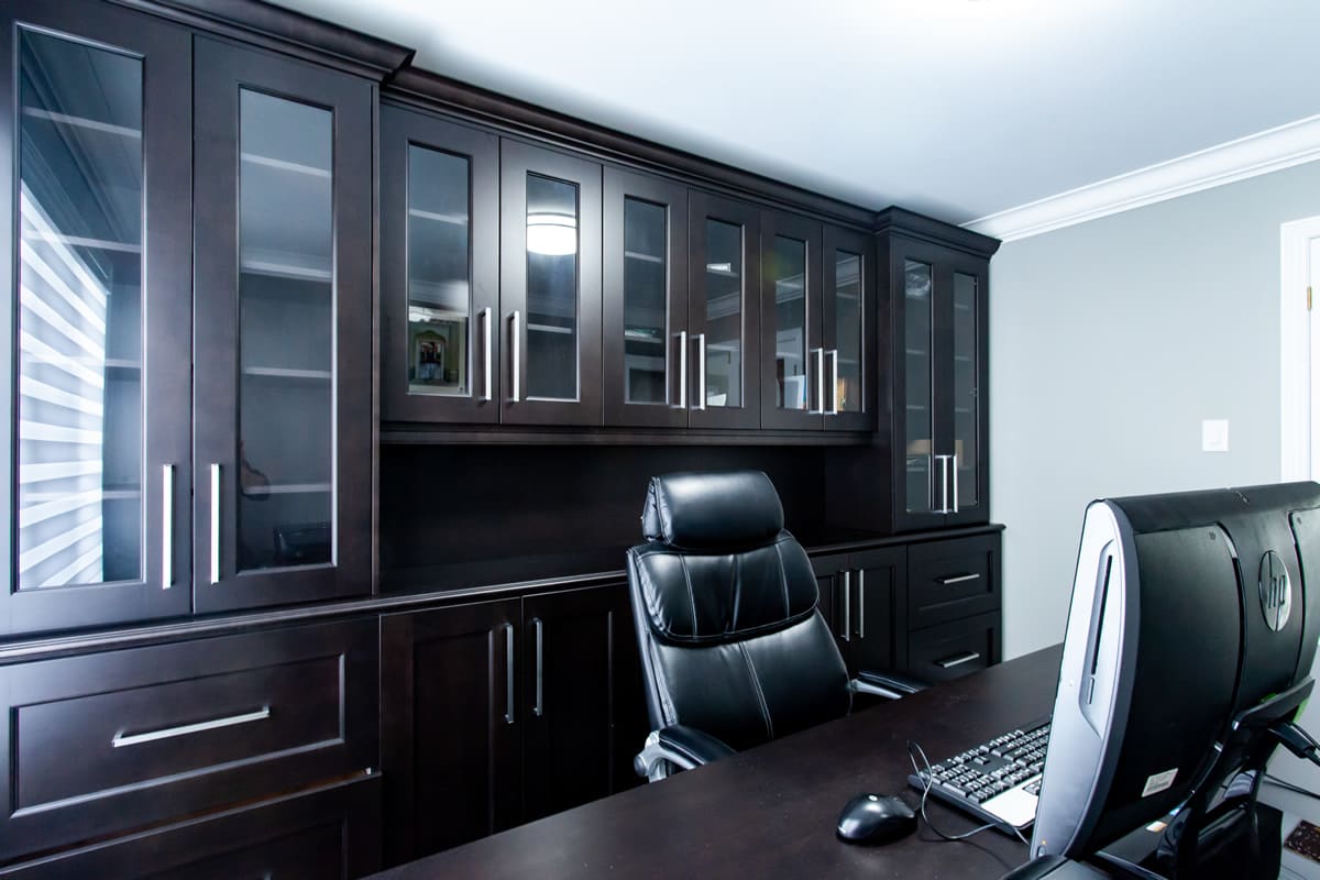 Home office with espresso glass-front built-ins