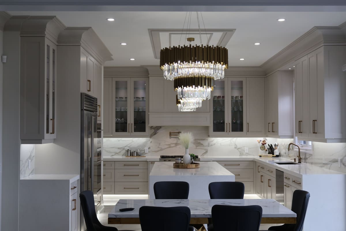 Taupe kitchen and dining area with a crystal chandelier